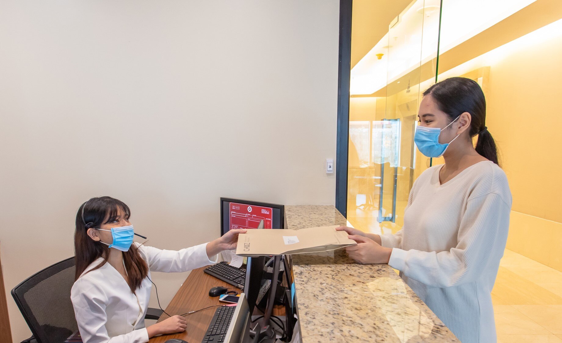 Receptionist helping clients at the front desk